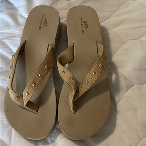 Tan flip flops